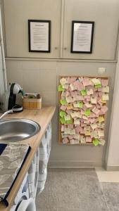 a bathroom with a sink and a pile of cards at Mermaid house apartman in Szeged