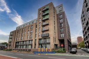 a large brick building on a city street at The Middlewood Plaza Suite - By Parydise Properties - Business or Leisure stays, Central Location, Sleeps 4, Salford in Manchester