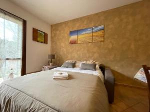 a bedroom with a bed with a towel on it at le piccole sorgenti in Bagni San Filippo