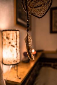 a dream catcher hanging from a table next to a lamp at Baraka Antigua in Antigua Guatemala