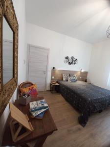 a bedroom with a bed and a mirror and a table at Affittacamere l'Aurora in Ceparana