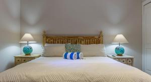 a bedroom with a white bed with two lamps at Palacio Blanco Luxury Villa 1 in La Ventana
