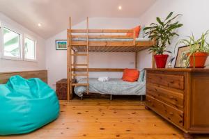 a bedroom with two bunk beds and a dresser at Gran casa familiar al lado de la playa in Santander