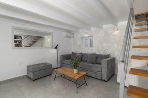 a living room with a couch and a table at CASA ANNA LOFT Boutique House with Full Sea View in Adamantas