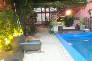 a patio with a pool and chairs and a house at CasaSanTelmo 2984 in Buenos Aires