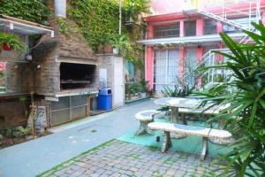 an outdoor patio with two benches and a table at CasaSanTelmo 2984 in Buenos Aires