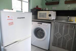 a kitchen with a washing machine and a microwave at CasaSanTelmo 2984 in Buenos Aires