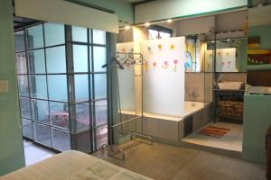 a room with a bathroom with a shower and a sink at CasaSanTelmo 2984 in Buenos Aires +21 photos