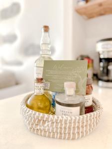 a basket filled with bottles of essential oils and a sign at Mountain Bliss Guesthouse 2 next to Sougia in Agrilés