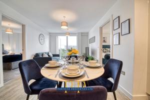 a dining room with a table and chairs at The Middlewood Plaza Suite - By Parydise Properties - Business or Leisure stays, Central Location, Sleeps 4, Salford in Manchester