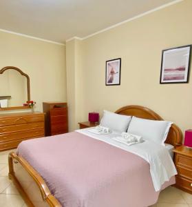 a bedroom with a large bed and a mirror at Sweet Home Riverside in Turin