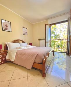 a bedroom with a bed and a large window at Sweet Home Riverside in Turin