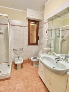 a bathroom with a sink and a toilet and a shower at Sweet Home Riverside in Turin +12 photos