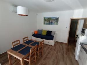 a living room with a table and a couch at Relax Apartment in Fonyód