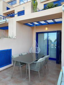 a patio with a black table and chairs at AURA MAR Mojácar Apartment in Mojácar