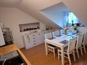 a kitchen and dining room with a table and chairs at Willa Krakowia in Krzeszowice
