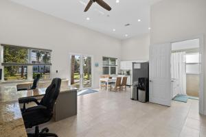 a living room with a ceiling fan and a kitchen at 2/1 Riverside Retreat with Loft in Fort Pierce