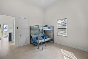 a room with a bunk bed and a window at 2/1 Riverside Retreat with Loft in Fort Pierce