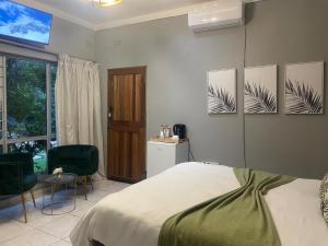 a bedroom with a bed and three pictures on the wall at The Bliss Boutique in Louis Trichardt +64 photos