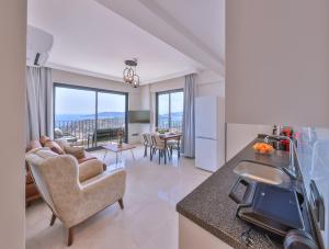 a kitchen and living room with a view of the city at Mare Vista Apart in Kaş