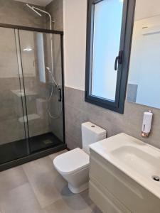 a bathroom with a toilet and a shower and a sink at Casa Natura Montseny in El Brull