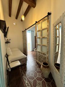 a bedroom with a bed and a window in a room at ANTICA DIMORA Santa Marina Salina in Santa Marina Salina