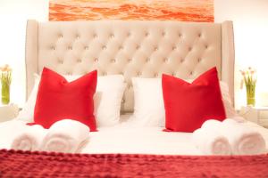 a bedroom with a white bed with red pillows at Lucky Home - Ideal for Trade, Consultants & Family - Near Alton Towers, 3 Bedrooms - 4 Beds - 5 People in Stoke on Trent