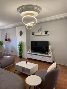 a living room with a couch and a tv at Nile View Cozy Appartment in Cairo
