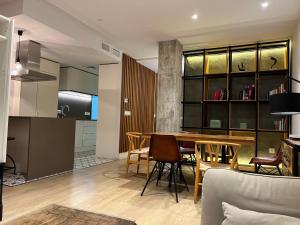 a living room and kitchen with a table and chairs at PIPA APARTMENTS in Almuñécar