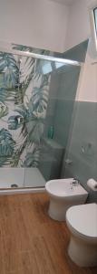 a bathroom with a toilet and a plant wall at Bellavista in Santa Flavia +46 photos