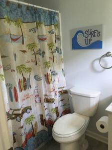 a bathroom with a toilet and a shower curtain at Surfside Beach/ Capt. Jacks ~50 FT From Beach 3br/3ba in Myrtle Beach
