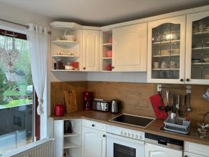 a kitchen with white cabinets and a sink at Henriette in Walkenried