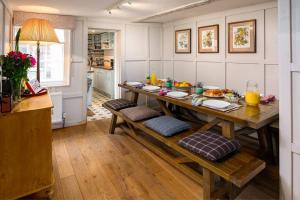 a kitchen with a wooden table with food on it at The perfect New Forest / coastal base. Sleeps 9. in Lymington