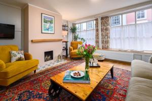 a living room with a table and a fireplace at The perfect New Forest / coastal base. Sleeps 9. in Lymington