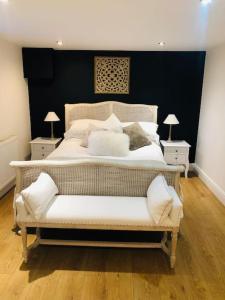 a bedroom with a large white bed with two night stands at 2 double bedroom large modern self contained apartment Free parking in Camberley