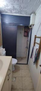 a small bathroom with a toilet and a sink at Alsancak seaside 50 m Single room green in Konak