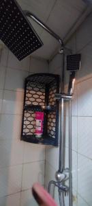 a bathroom with a shower with a shelf on the wall at Alsancak seaside 50 m Single room green in Konak