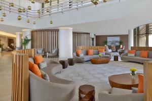 a lobby with couches and tables in a building at Marriott Riyadh Diplomatic Quarter in Riyadh
