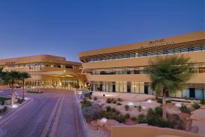 duży budynek z palmą przed nim w obiekcie Marriott Riyadh Diplomatic Quarter w Rijadzie