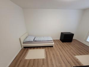 a small room with a bed and a dresser at Apartmán Neva Šaľa in Šaľa