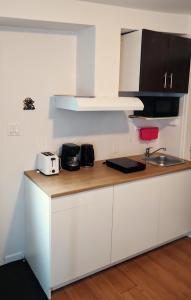 a kitchen with a counter with a toaster and a sink at welcome to airbnb in Saint-Jean-sur-Richelieu