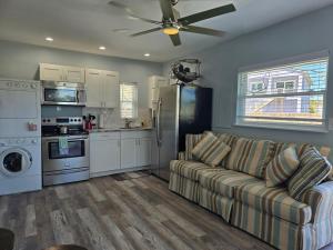 a living room with a couch and a kitchen at Iguana Updated Home By Large Imperial River 1 Mi to Beach in Bonita Springs