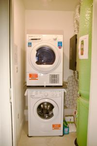 a washing machine sitting on top of a washer at Mary St House 3A in Dublin