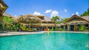 a swimming pool in front of a villa at Cabarete Bech Royal Puerto Plata in Cabarete