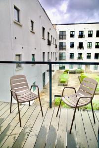 two chairs sitting on a deck in a building at Mary St House 3A in Dublin