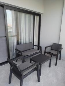 3 chaises et tables dans une pièce avec fenêtre dans l'établissement Condominio Sal Rei APT 206, à Sal Rei