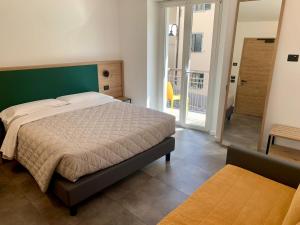 Postel nebo postele na pokoji v ubytování Hotel Locanda Alla Perla