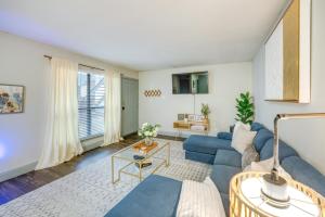 a living room with a blue couch and a table at Dallas Apartment with Pool Access, 10 Mi to Downtown in Dallas