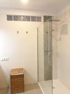 a bathroom with a shower with a glass door at Apartamento con impresionantes vistas en Los Gigantes - Crab Island in Puerto de Santiago +47 photos