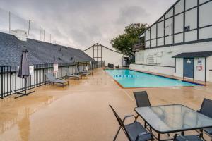 a flooded swimming pool with tables and chairs in front of a building at Charming Dallas Apt with Fireplace and Pool Access! in Dallas